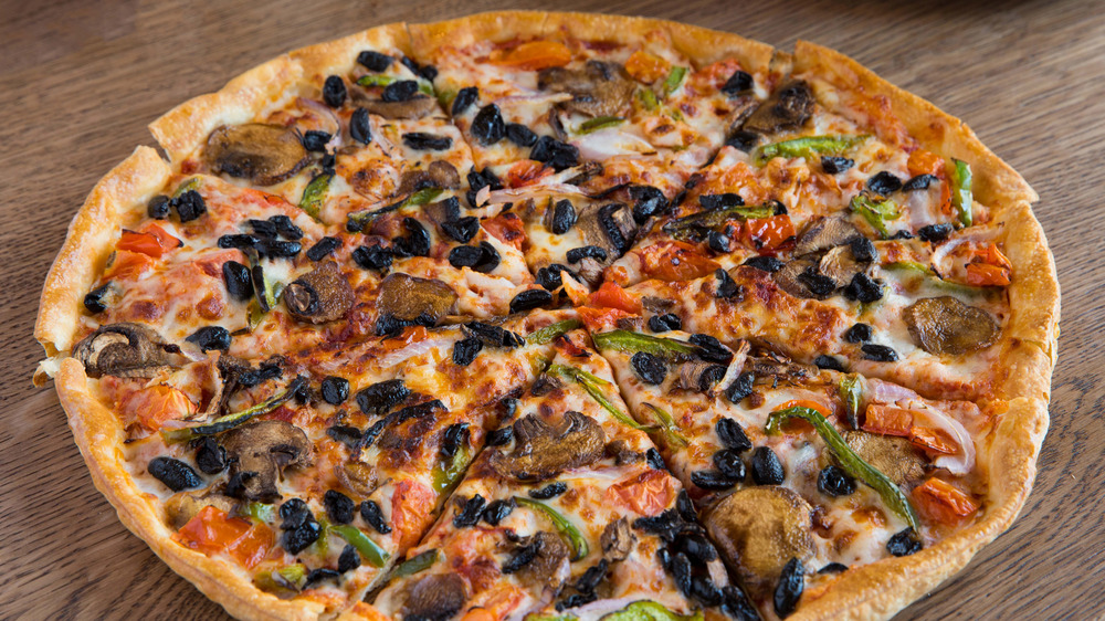 Vegetable pizza on dark wood