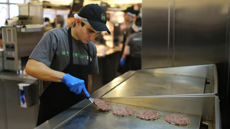 person grilling burgers