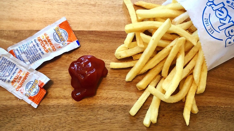 Packet of Baker's ketchup next to fries