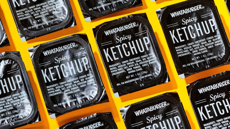 Rows of Whataburger Spicy Ketchup pots
