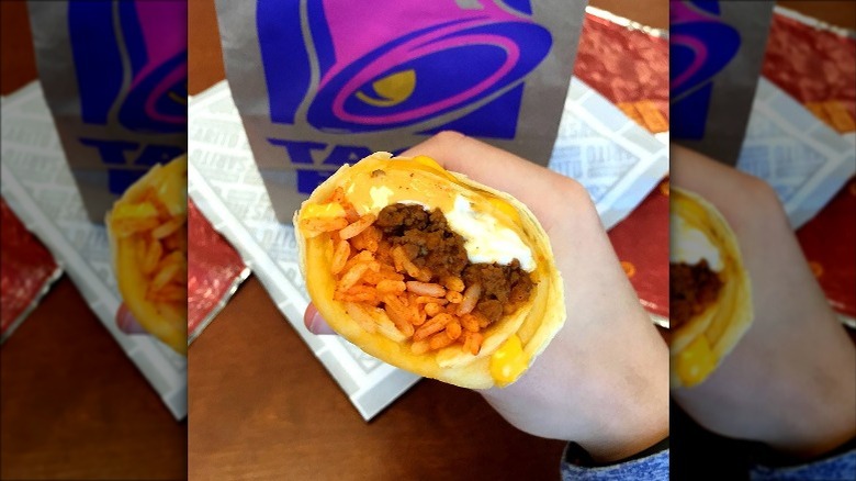 Man holding Taco Bell Quesarito