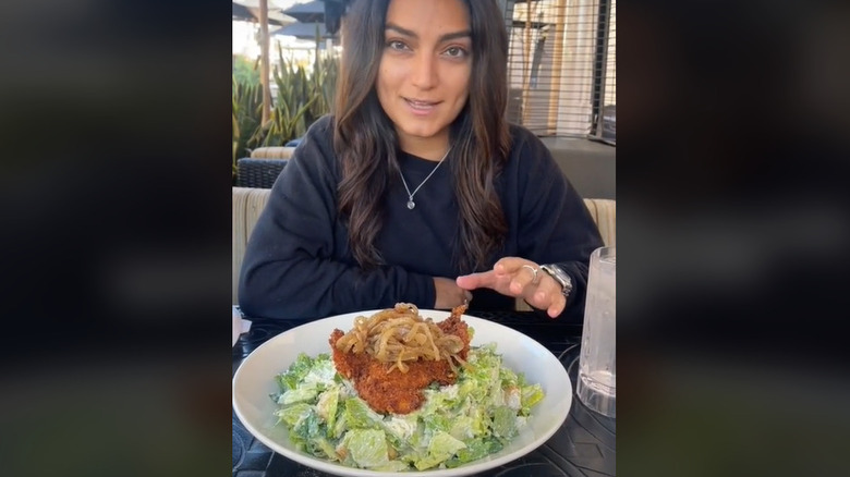 woman and chicken Caesar salad