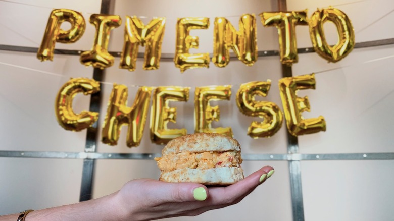 hand  holding Pimento Cheese Biscuit