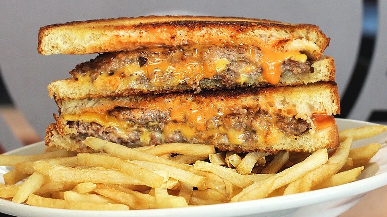Sliced patty melt and fries
