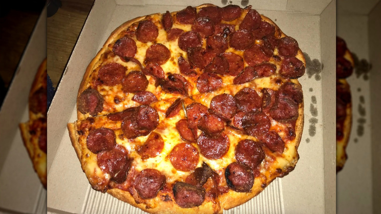 Greasy pepperoni pizza sliced up