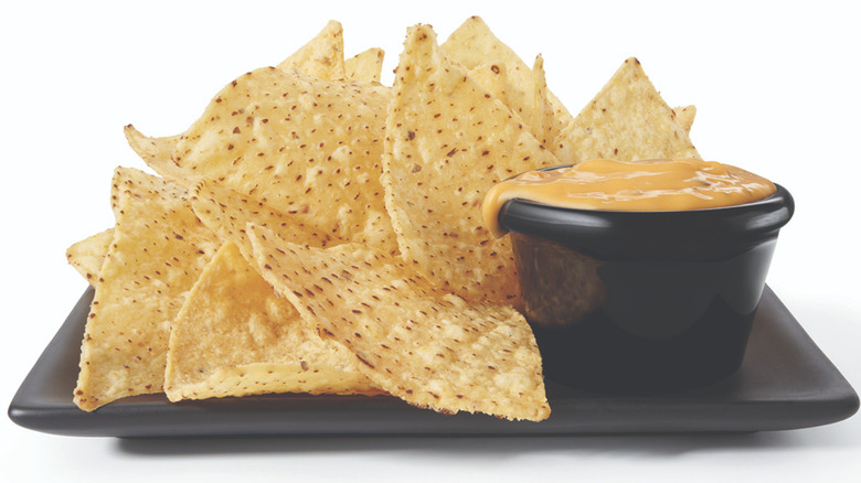 queso cheese dip held by woman 