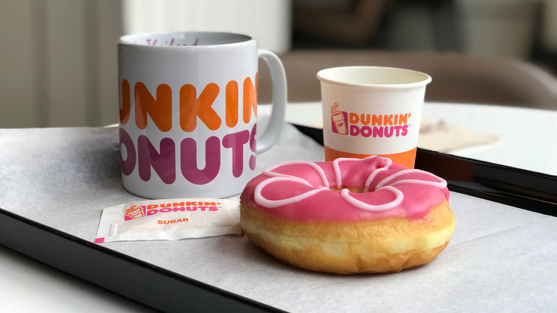 Dunkin' coffee cups and a donut