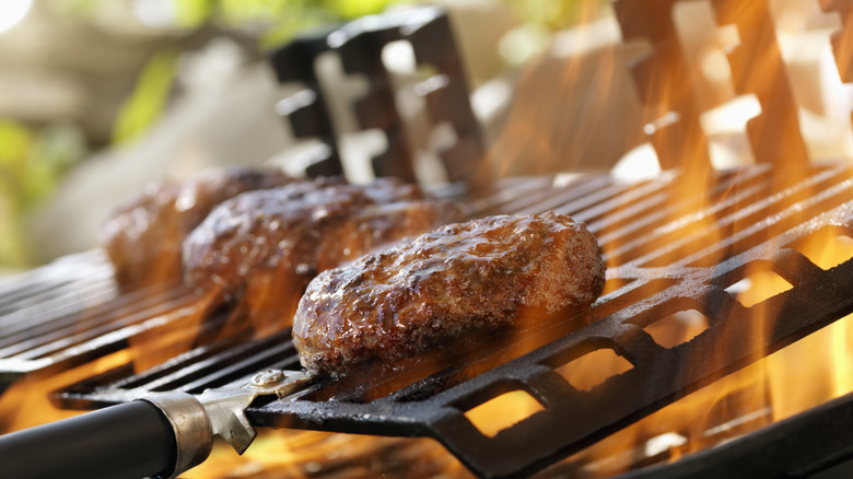 burger patties on open flame