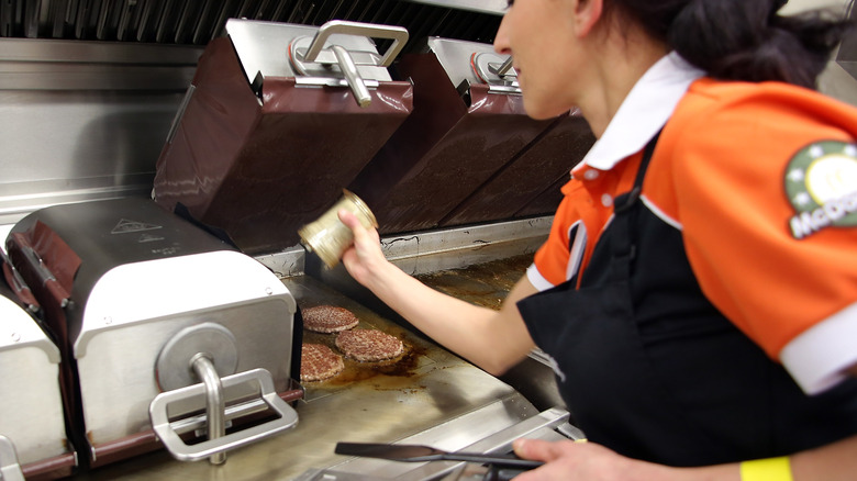 McDonald's employee cooking burgers