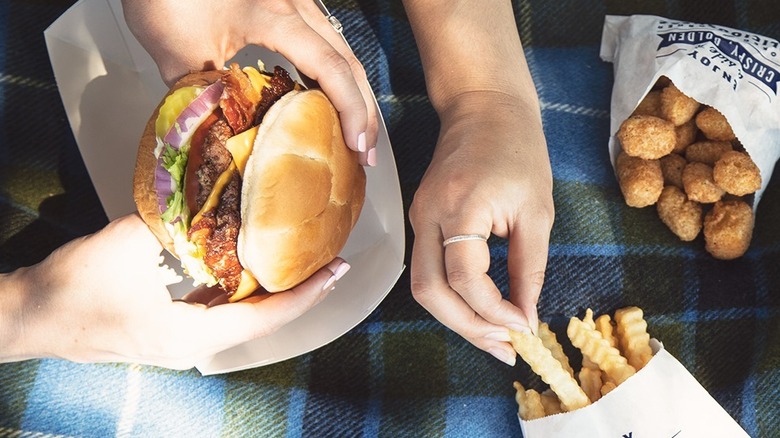 Customer holding Culver's Butterburger