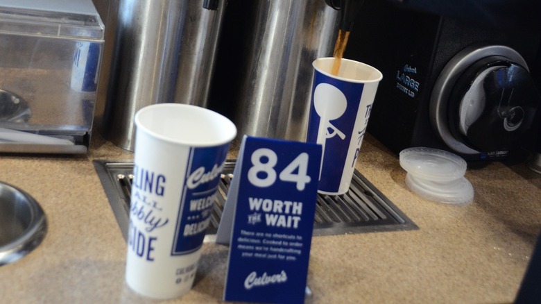 Two Culver's cups, tea being poured in the back