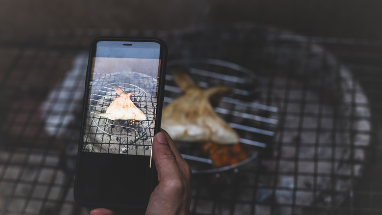 chef taking picture collar grilling