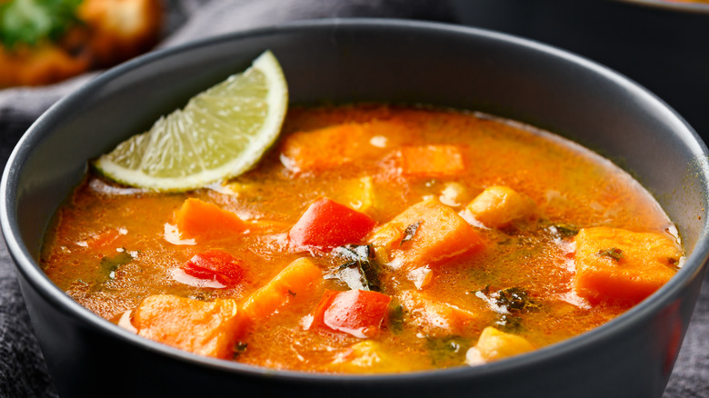 Pumpkin chicken chili in black bowl