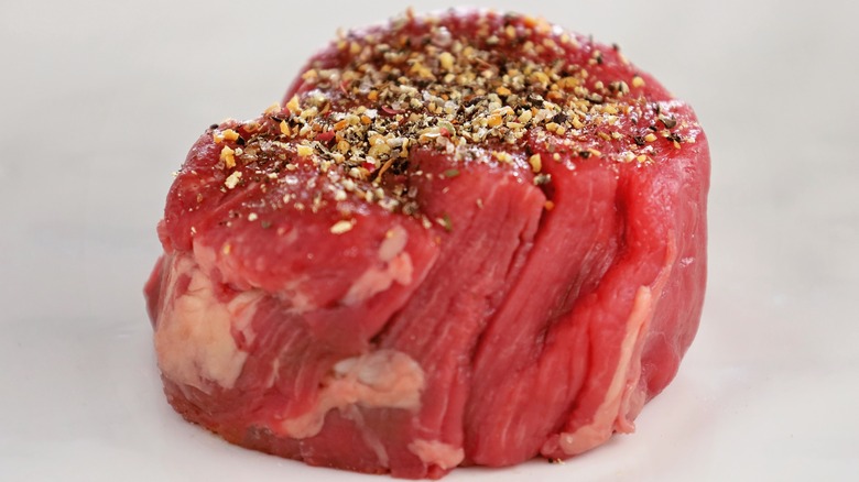 raw filet mignon with seasoning