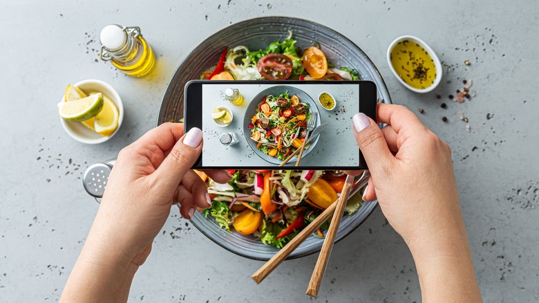 Person taking photo of their salad with smart phone