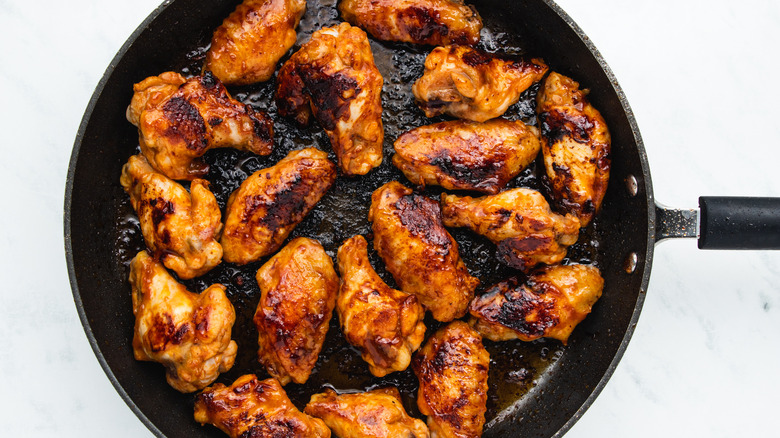 seared chicken wings in skillet