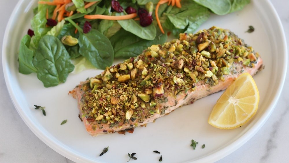 pistachio crusted salmon with salad and lemon slice