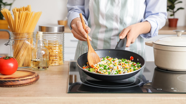 person cooking on the stove