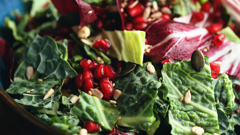 Pomegranate seeds on kale salad