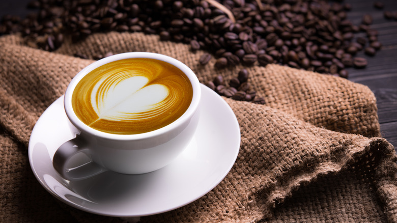 A latte with coffee beans