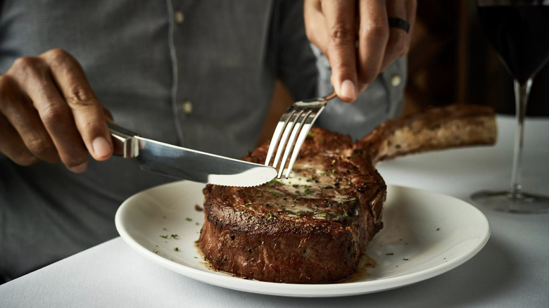 Man eating steak at Fleming's 