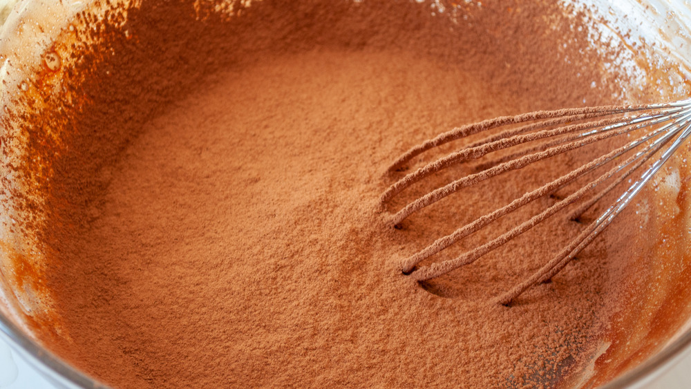 whisking cocoa powder into cake batter