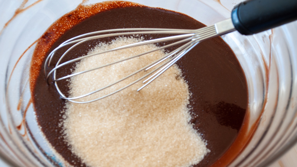 whisking sugar and salt into chocolate