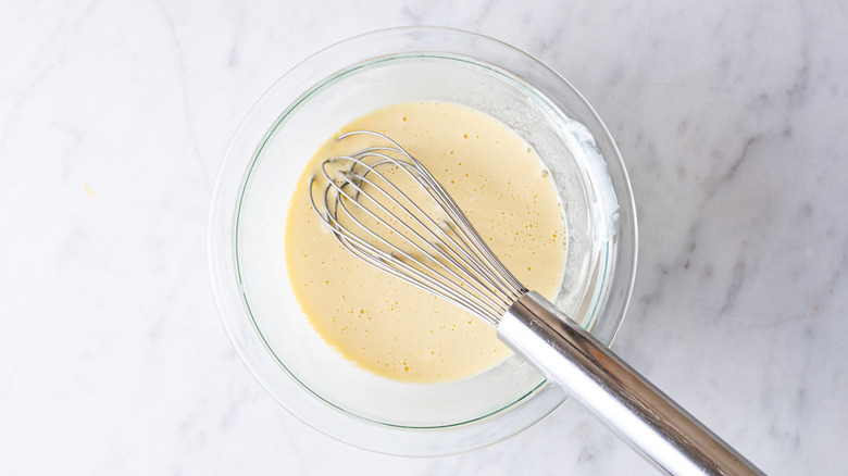 wet ingredients for blini in a bowl