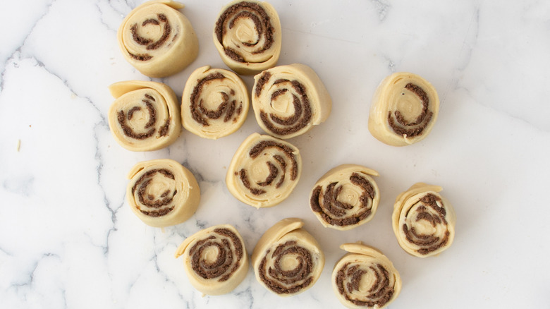 dough pinwheels with a brown filling on a white countertop