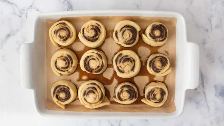 dough pinwheels in a white pan on a white countertop