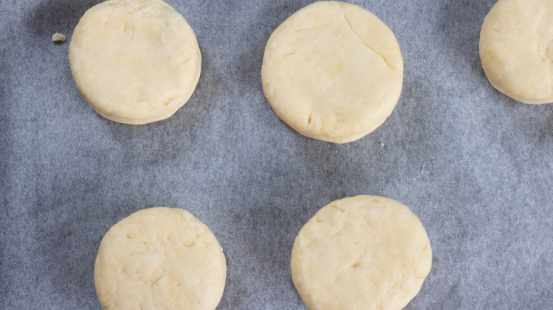 cut biscuit dough on tray