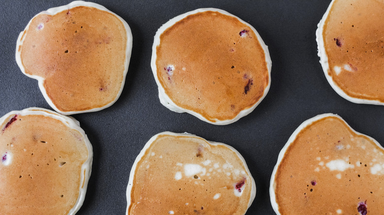 Cooked homemade strawberry pancakes on a griddle