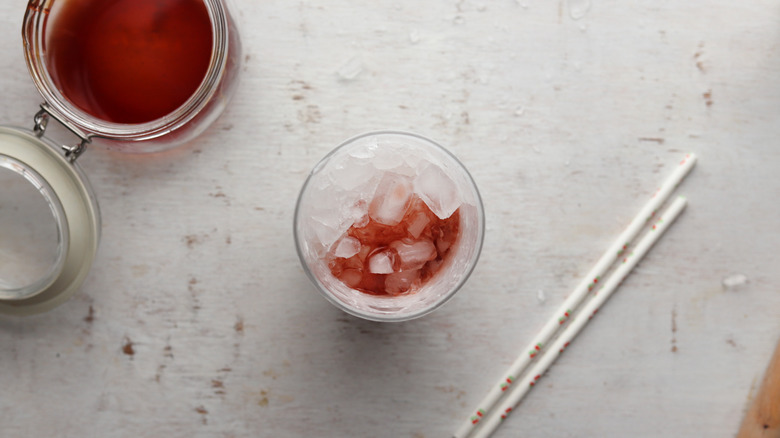 crushed ice and cherry syrup in a glass