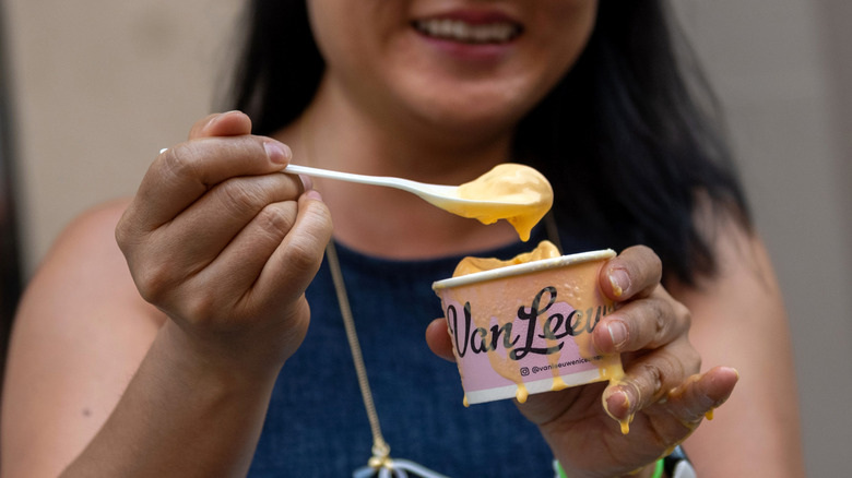 Person eats melting macaroni and cheese ice cream