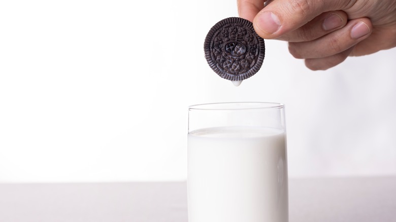 Oreo being dunked into milk