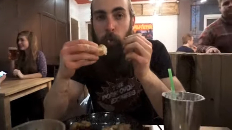 Adam Moran doing the Yorkshire Pudding Burger Challenge