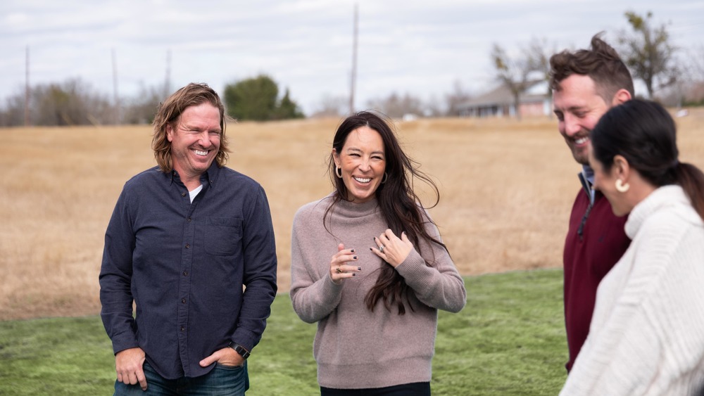 Joanna and Chip Gaines smiling in field