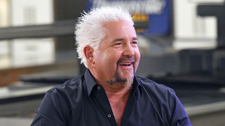 Guy Fieri smiles looking left