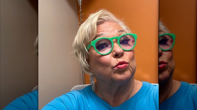 Nancy Fuller wears bold green glasses