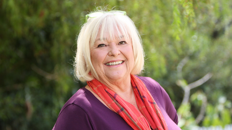 Nancy Fuller wears a colorful scarf with a brightly colored shirt