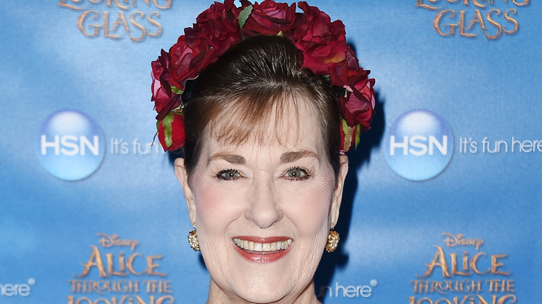 kerry vincent on red carpet with floral headdress