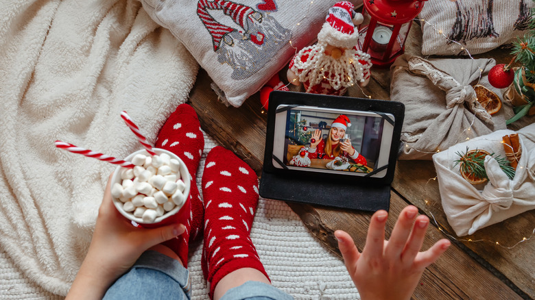 Woman watching Christmas show on phone