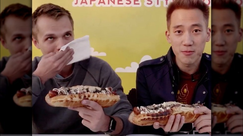 Two men eating Juuni Bans 