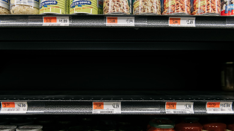 Empty shelf below canned goods