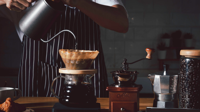 barista pouring coffee in a chemex