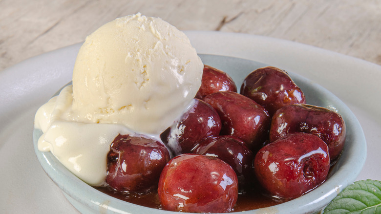 Cherries Jubilee and ice cream on a white dish