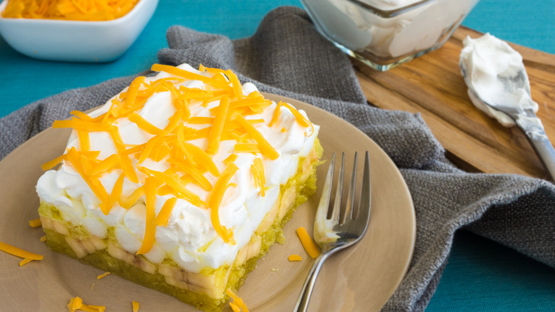 Hawaiian Jello salad topped with shredded cheese