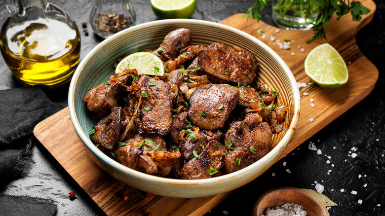 Fried chicken livers and onions in an orange bowl