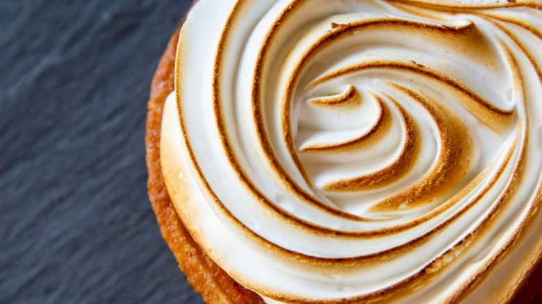 meringue topped pie on blue background