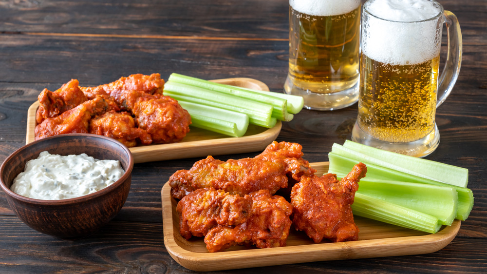 Buffalo chicken wings with dip and pints of beer